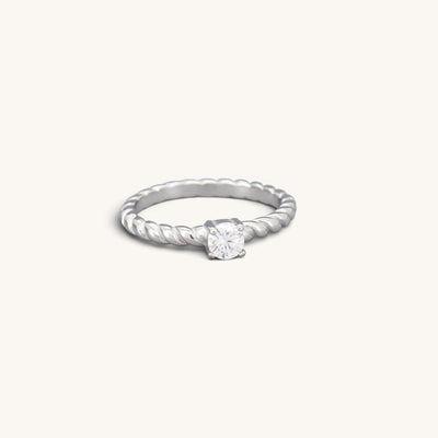 Silver tone stainless steel twisted solitaire ring with a round clear CZ stone