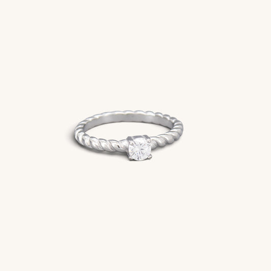 Silver tone stainless steel twisted solitaire ring with a round clear CZ stone